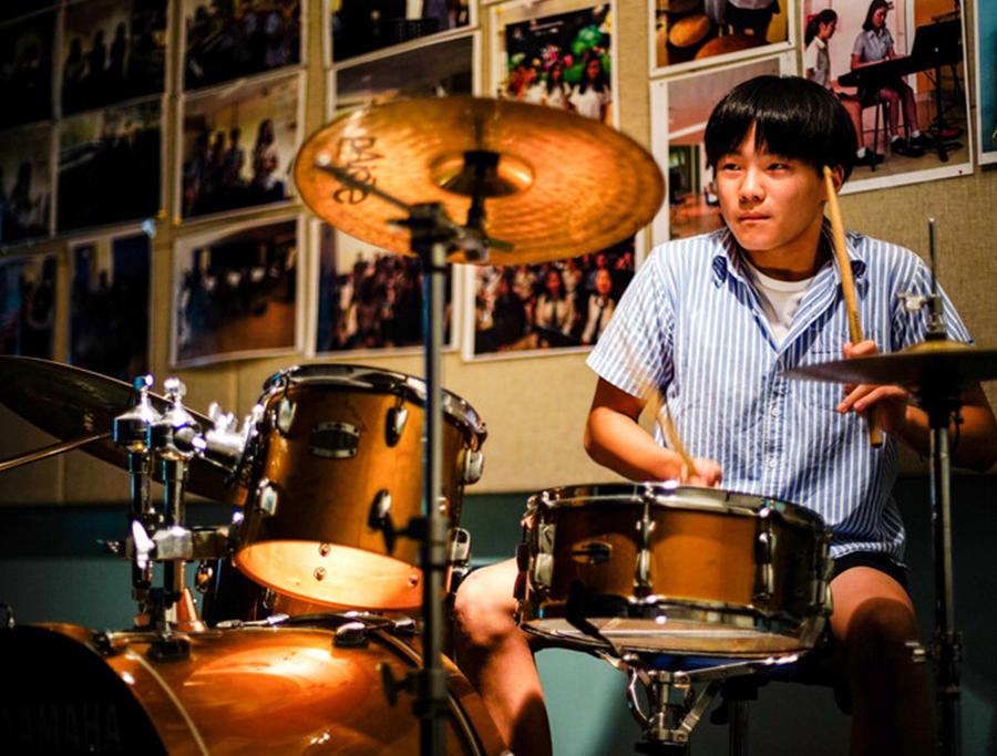 Secondary-student-playing-drums Secondary-student-playing-drums