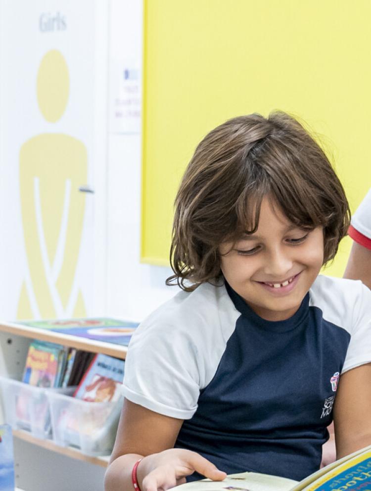 teacher reading book to kindergarten