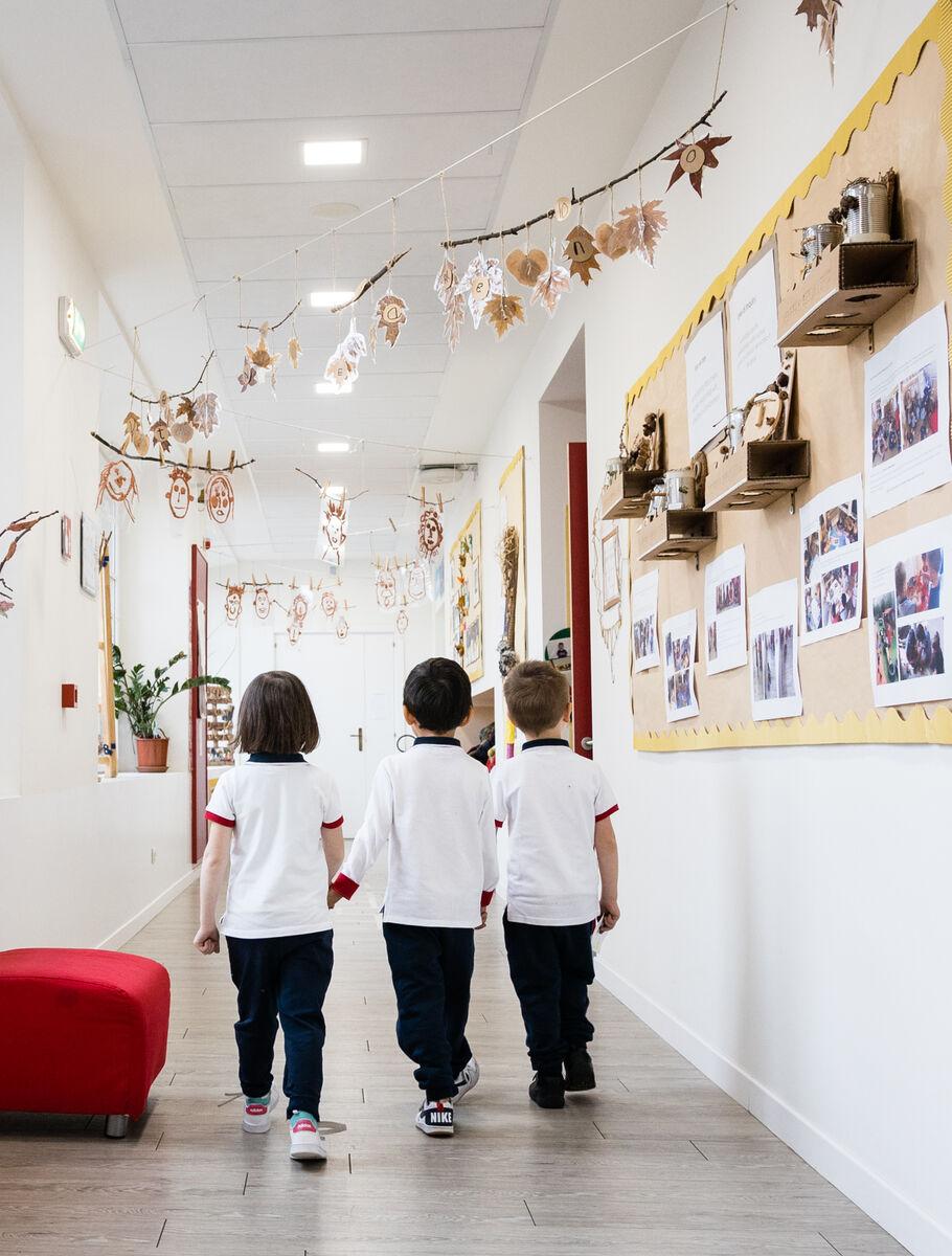 kindergarten students walking down corridor