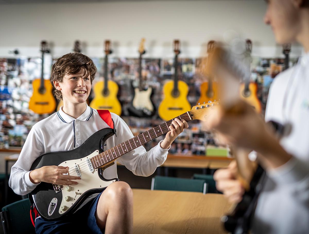 ACG Parnell student playing guitar