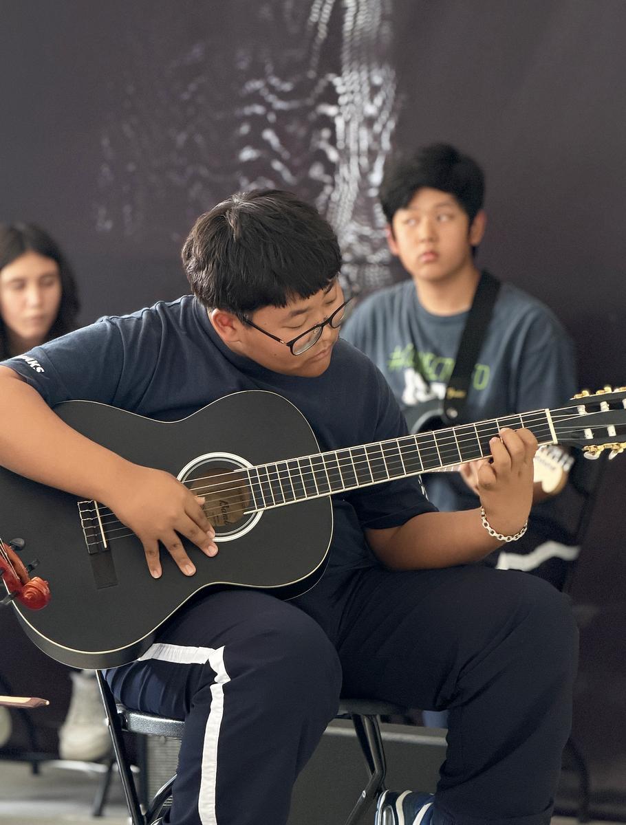 Student playing guitar