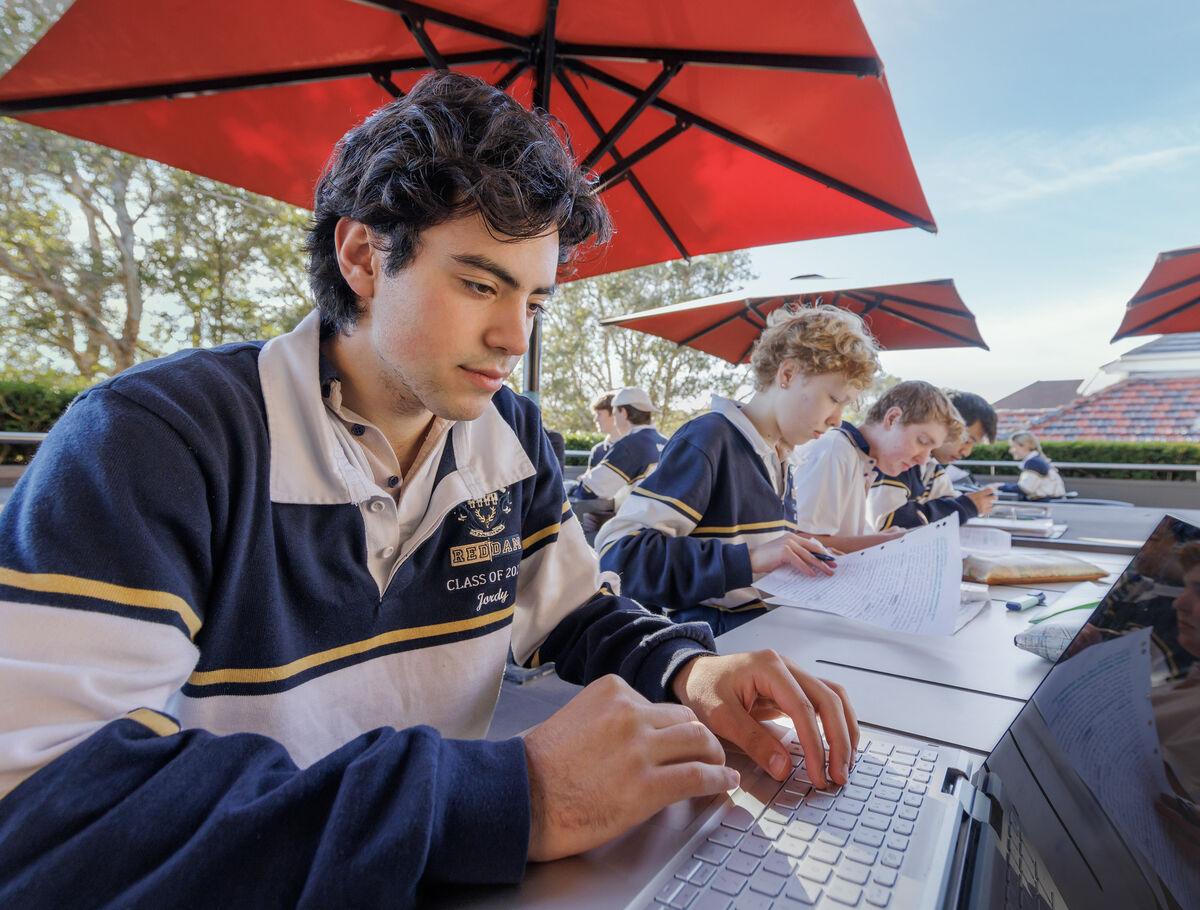 student_working_on_rooftop_space