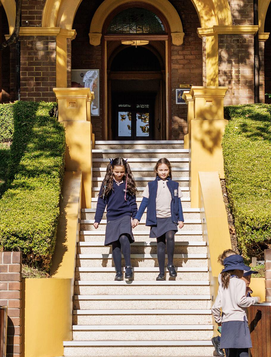 students_on_steps_front_of_school