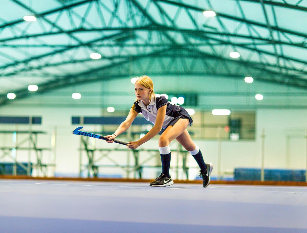 Student playing hockey