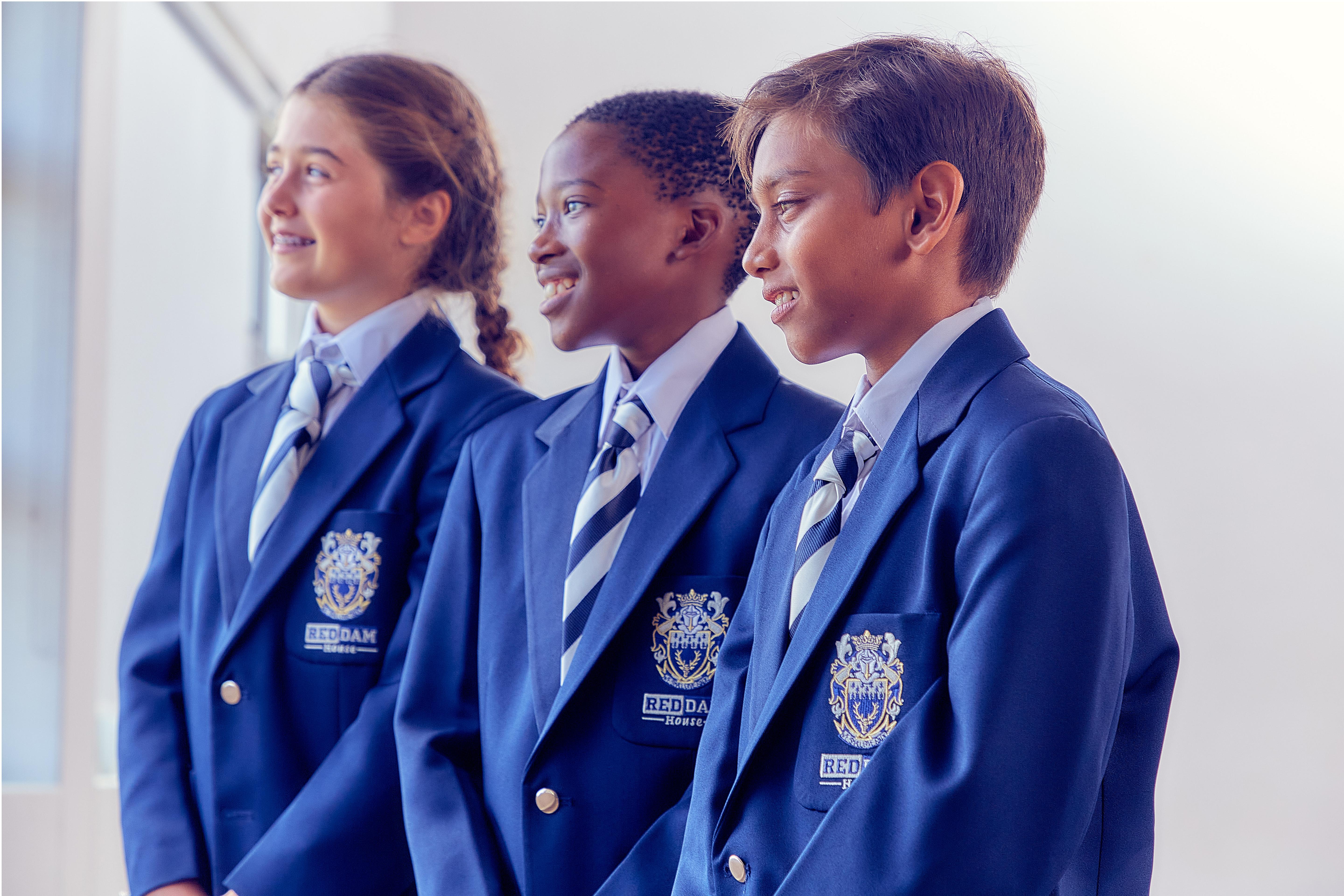 Three students standing together and smiling