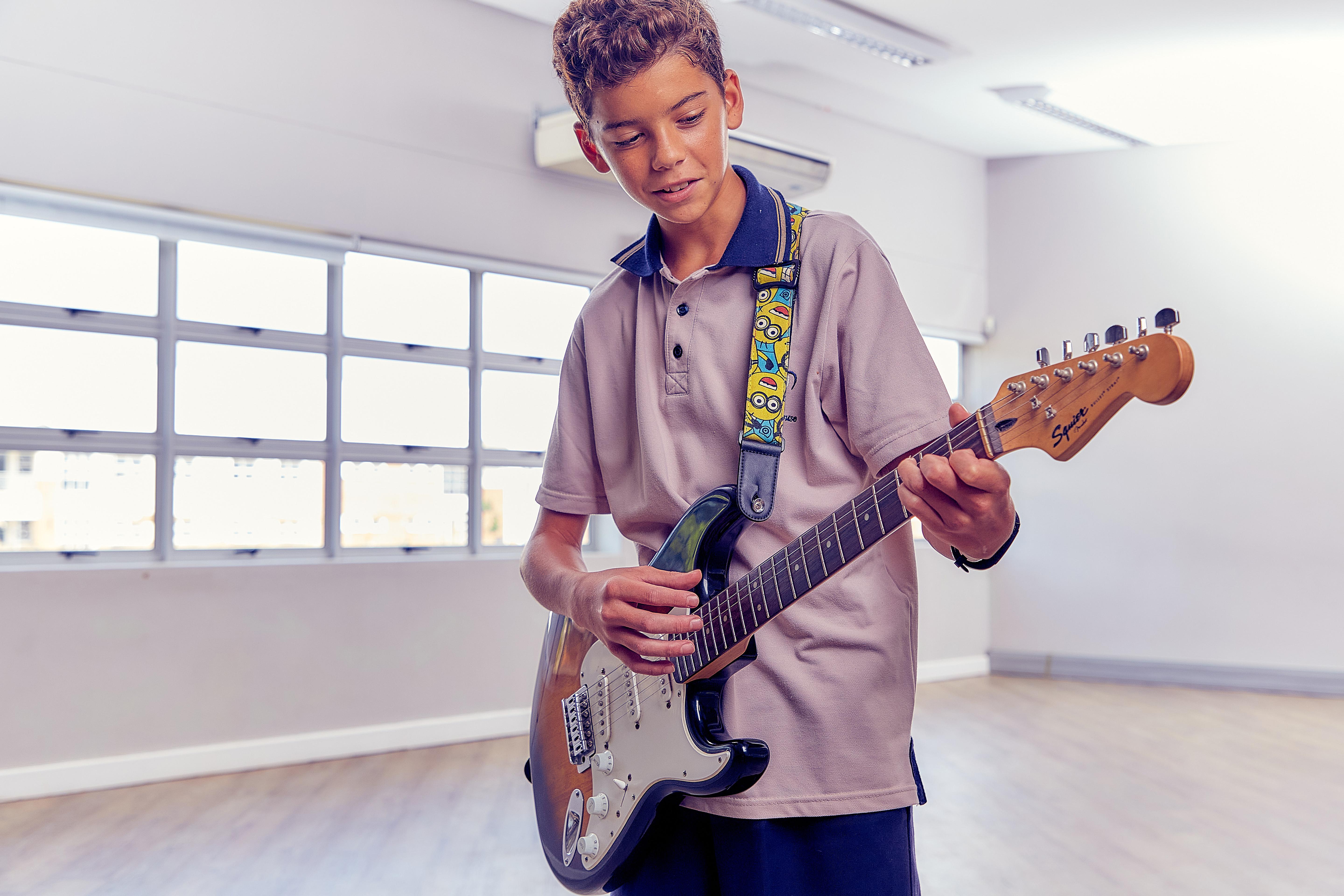 Student holding a guitar