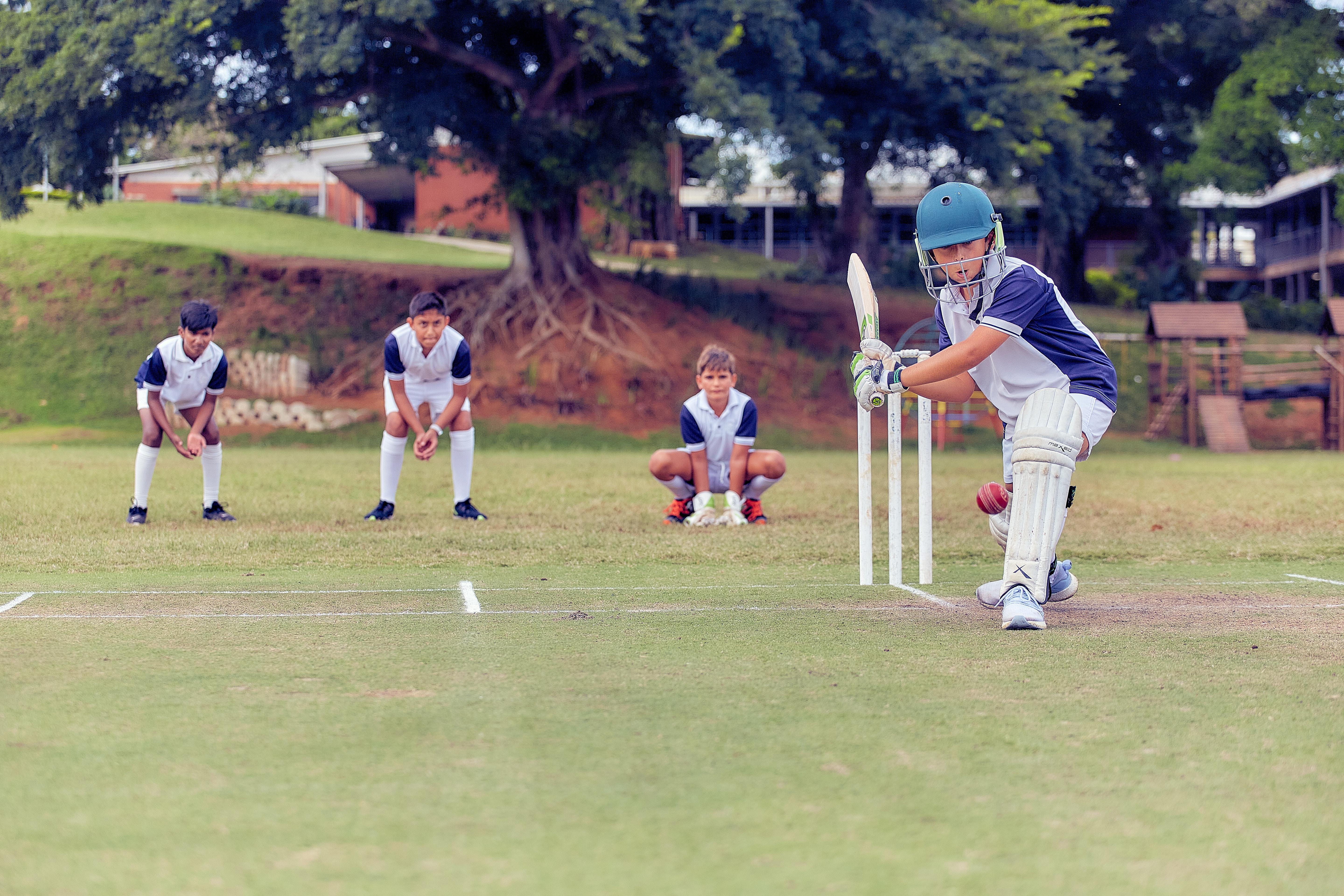 Students playing cricket