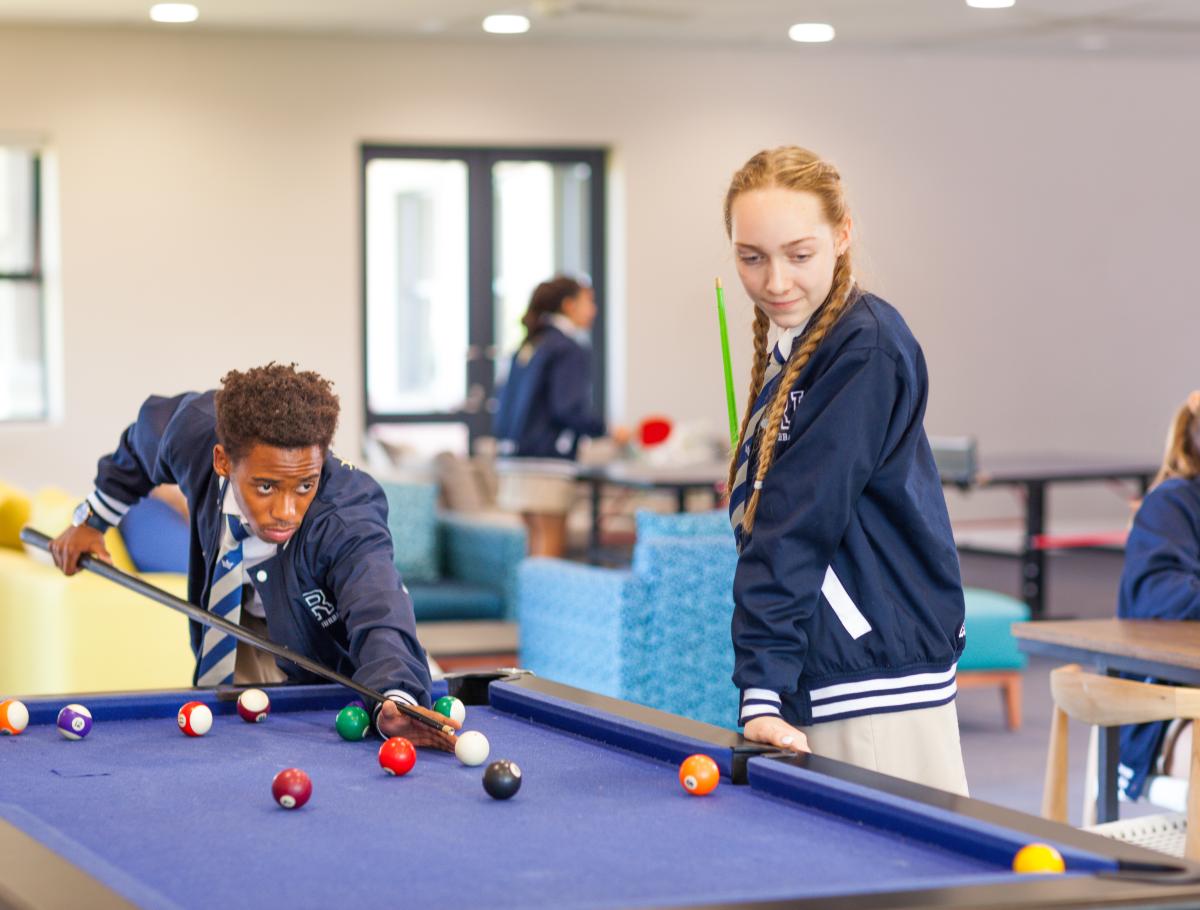 Two students playing pool