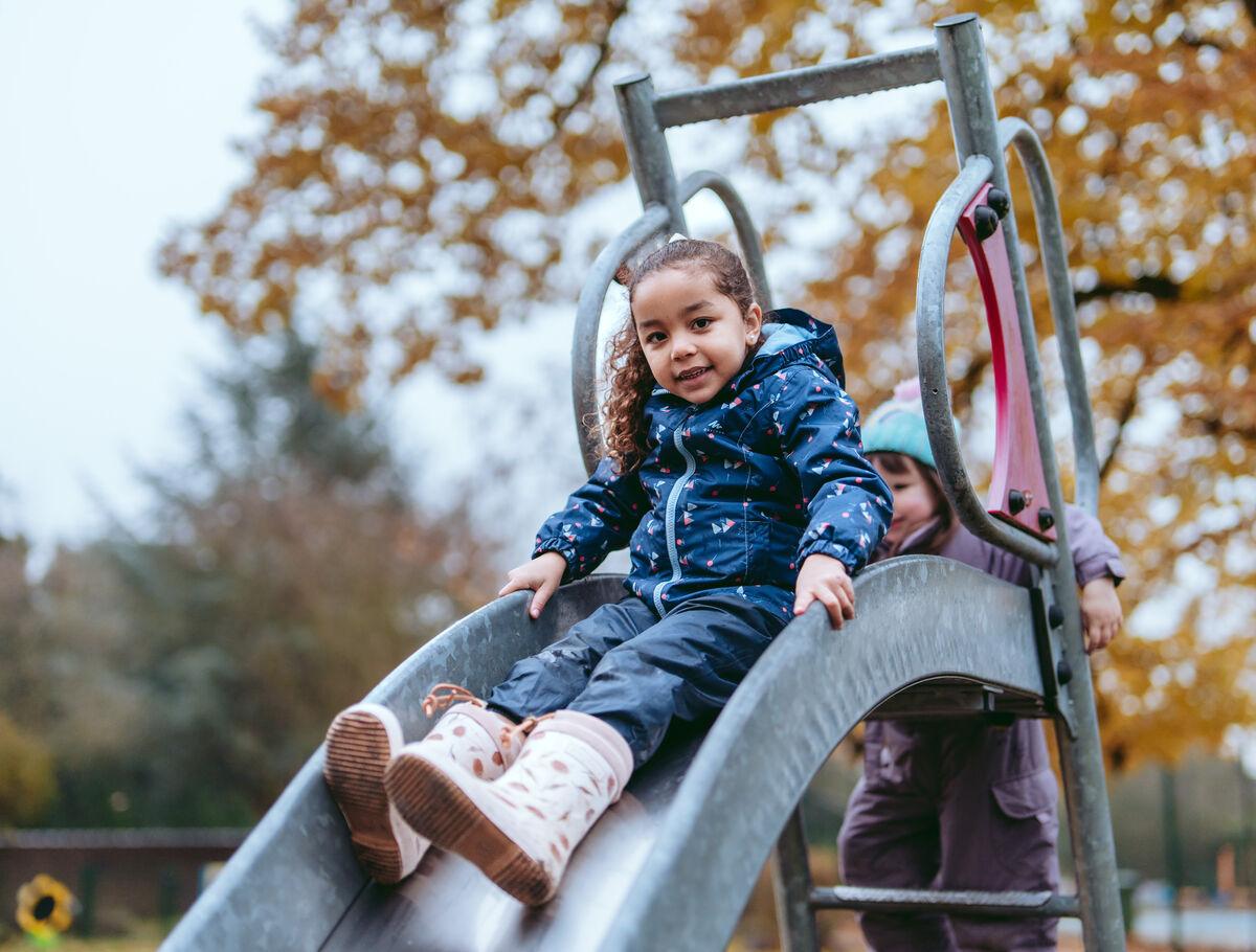 els_student_on_playground_slide