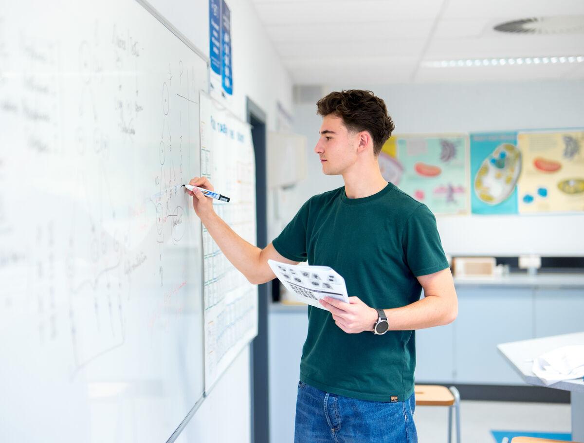 senior_student_writing_on_the_board