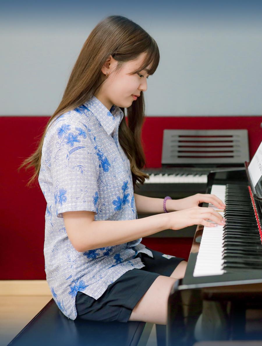 Student playing piano Student playing piano