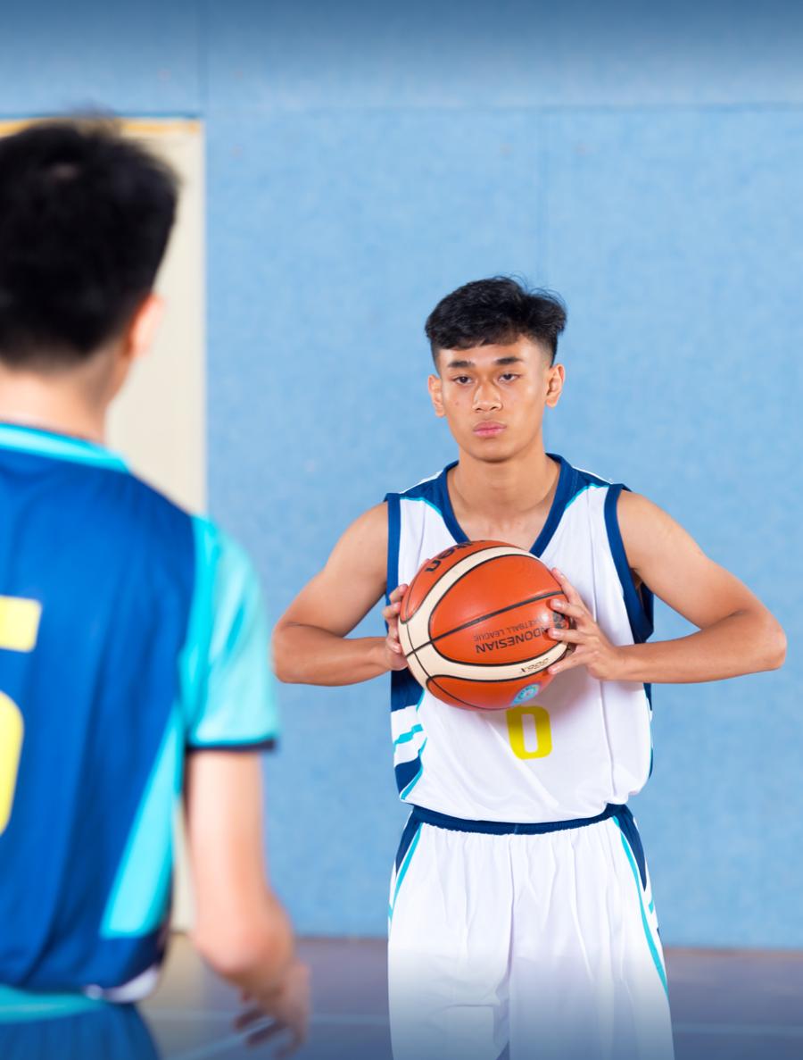 Student playing basketball Student playing basketball