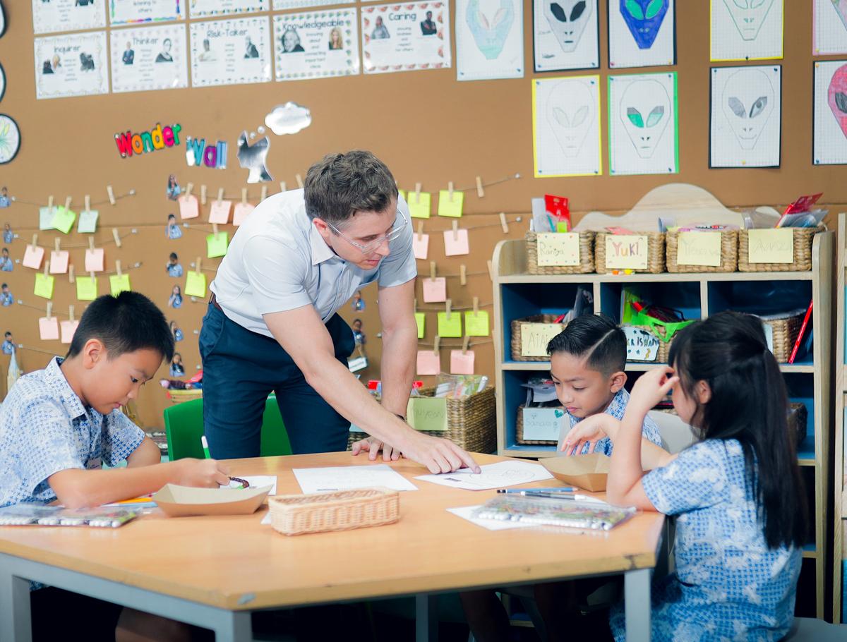 Teacher helping students
