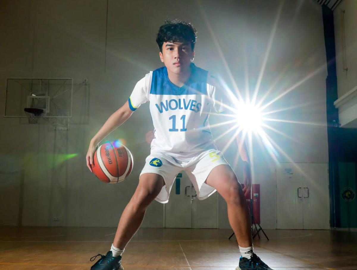 Student dribbling basketball