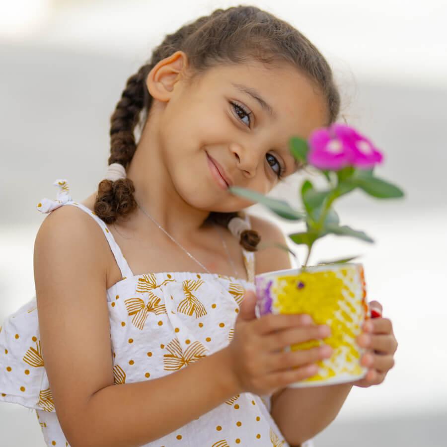 Student holding flower pot