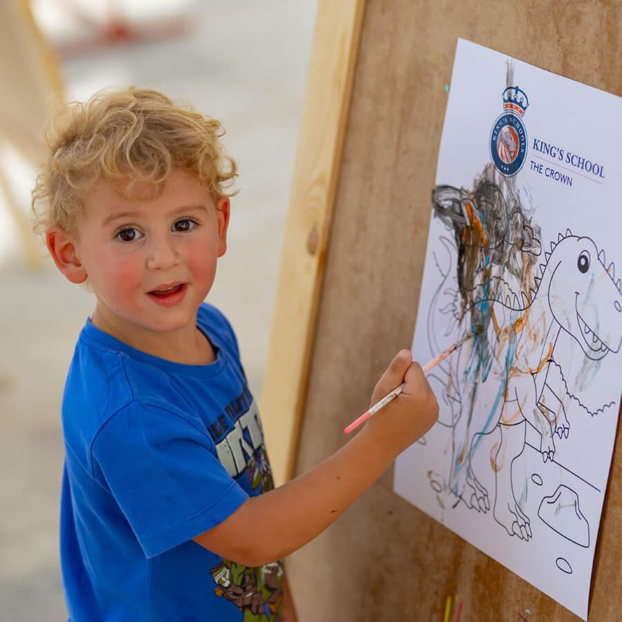 Student painting dinosaur