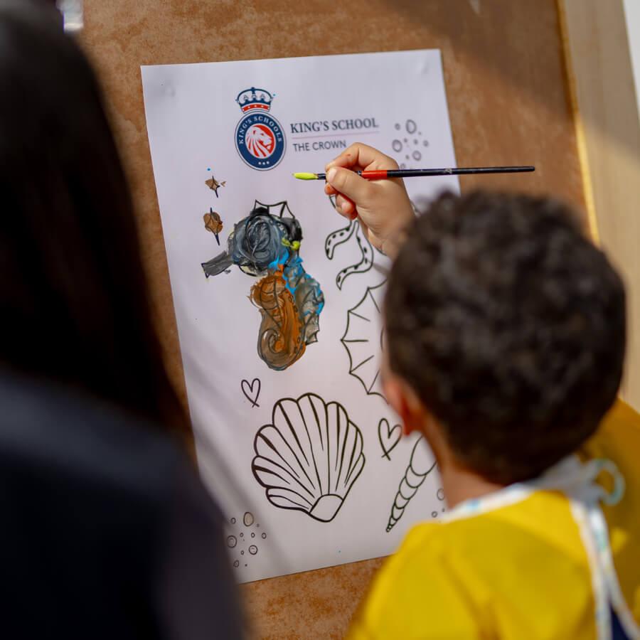 Student painting sea animals