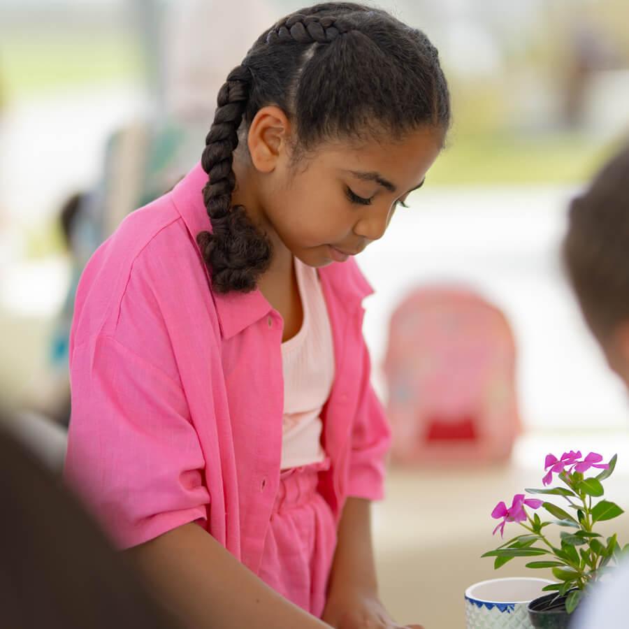 Student next to flowers