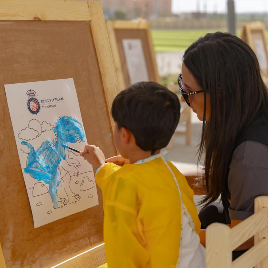 Teacher helping paint