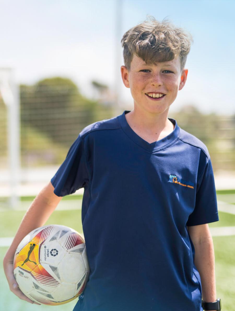 Student holding soccer ball