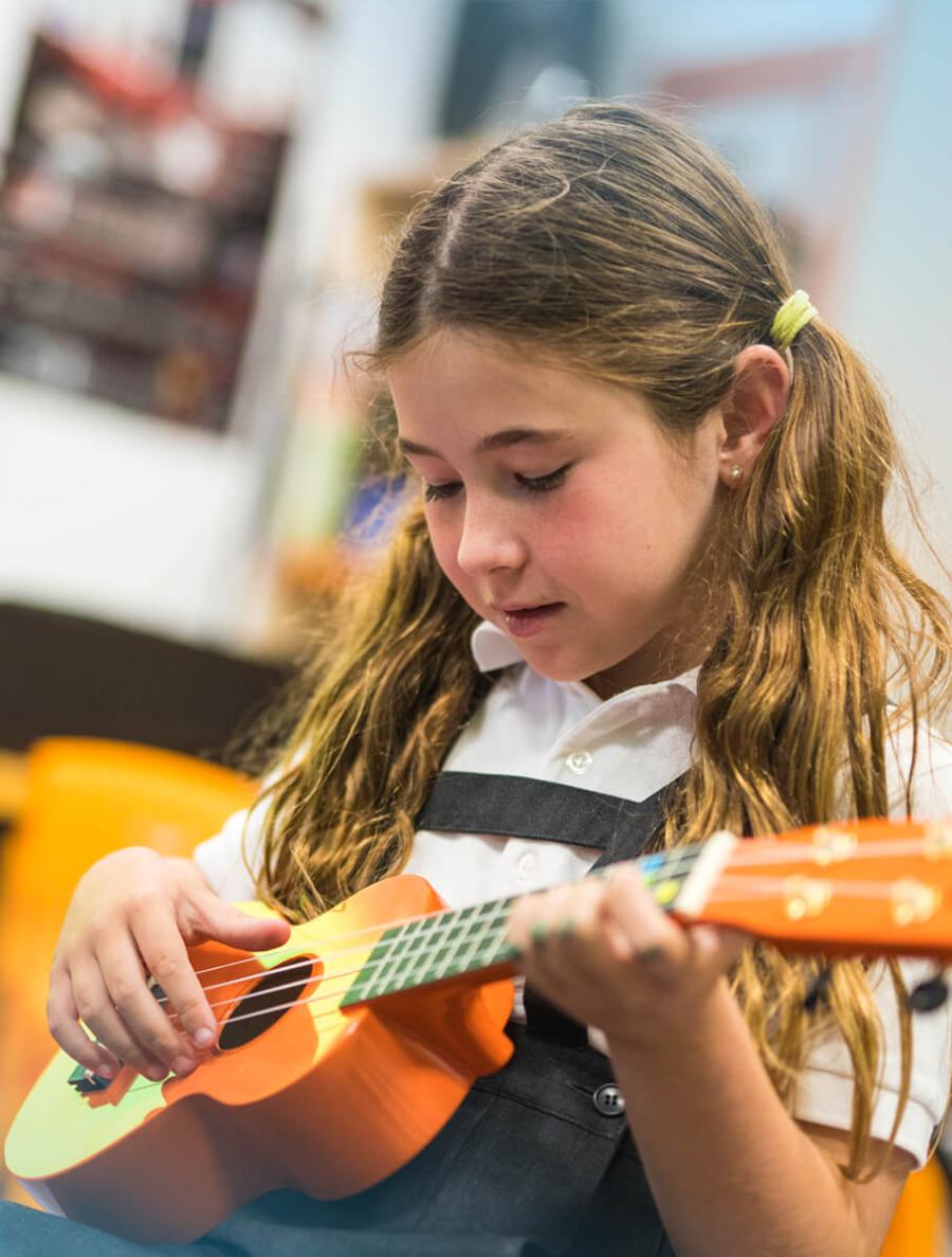 Student playing guitar