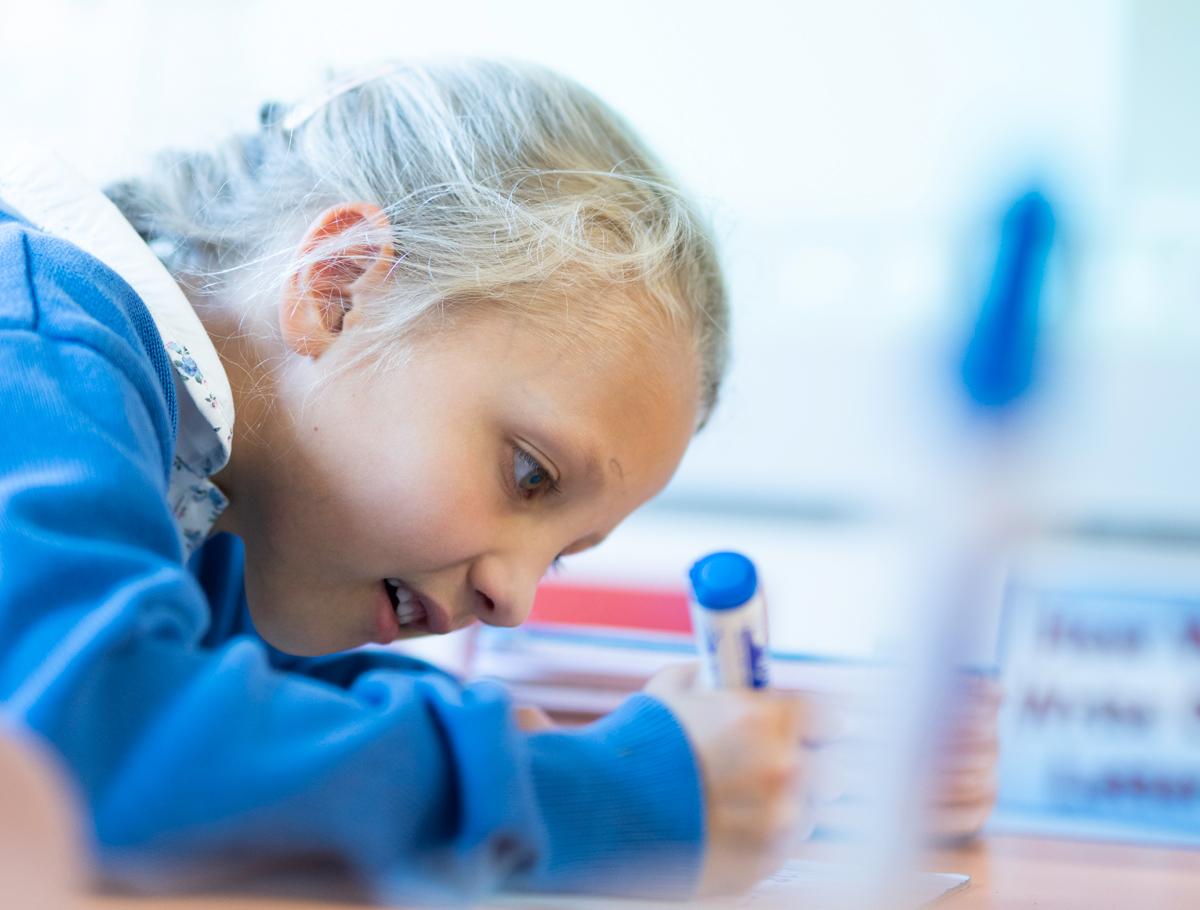 Student writing on whiteboard