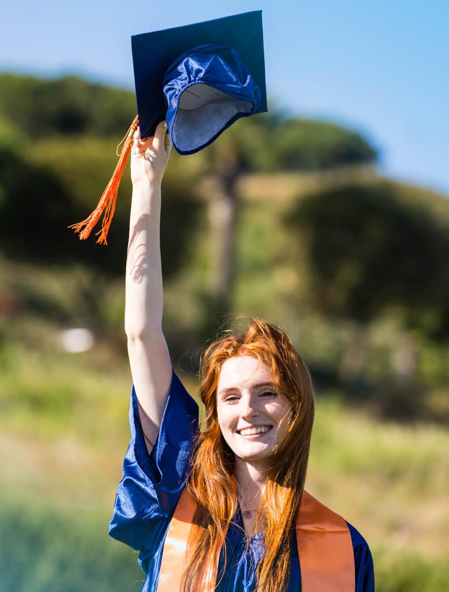 Graduate holding mortarboard