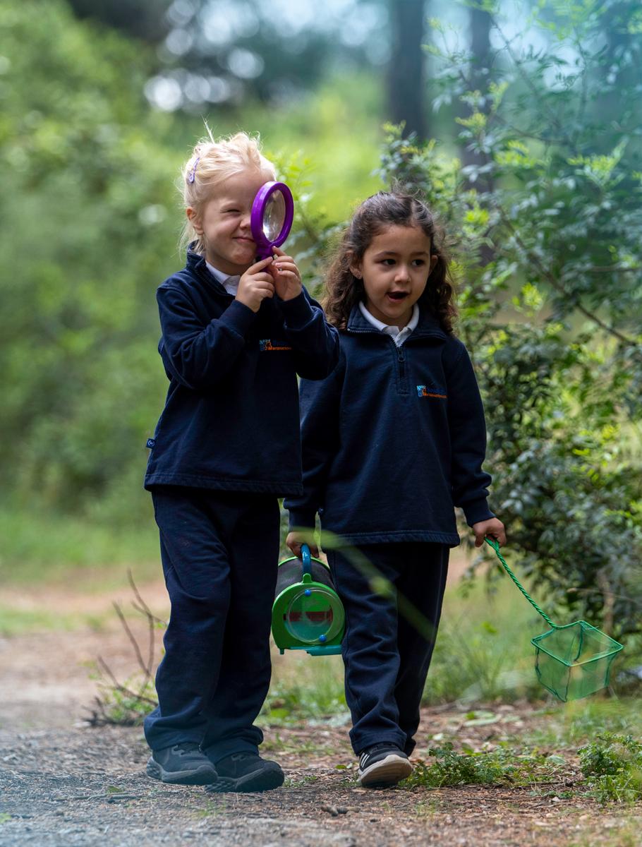 Kid looking through magnify glass