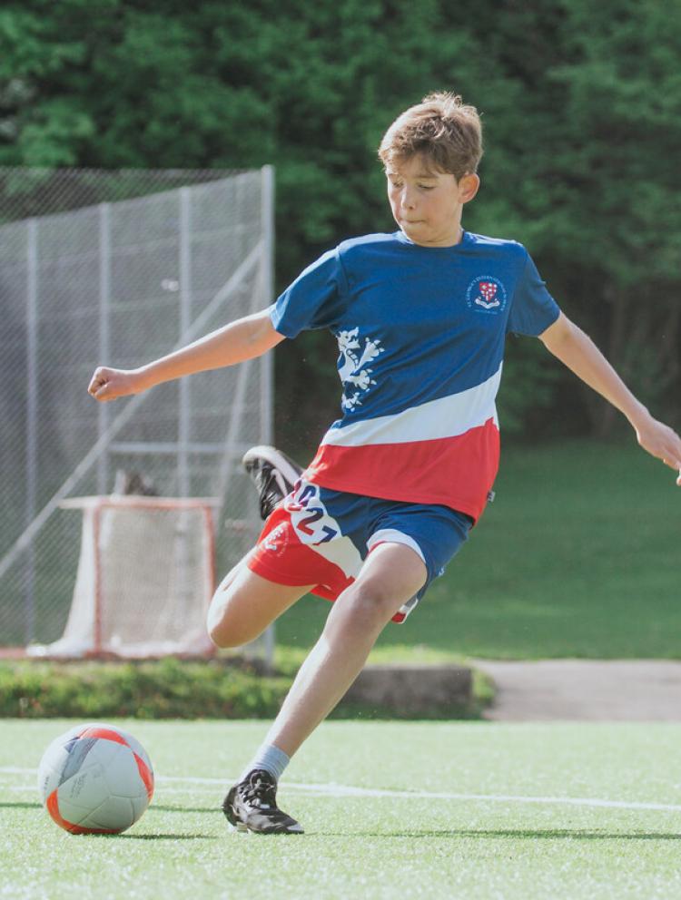 high school student playing football outside