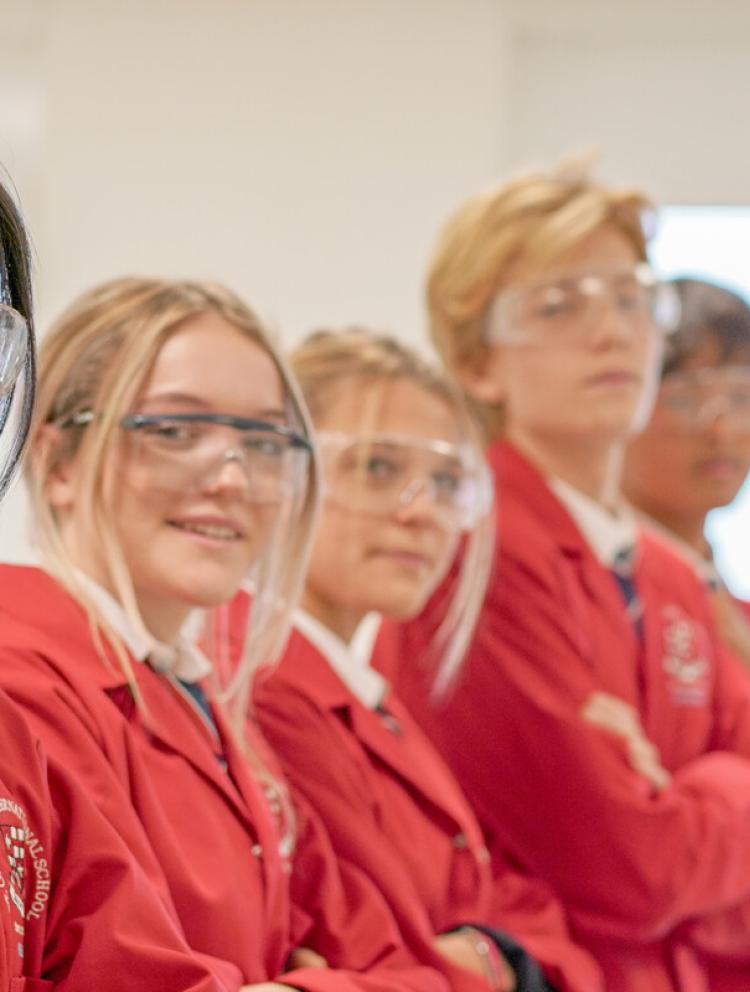 secondary students in red lab coats