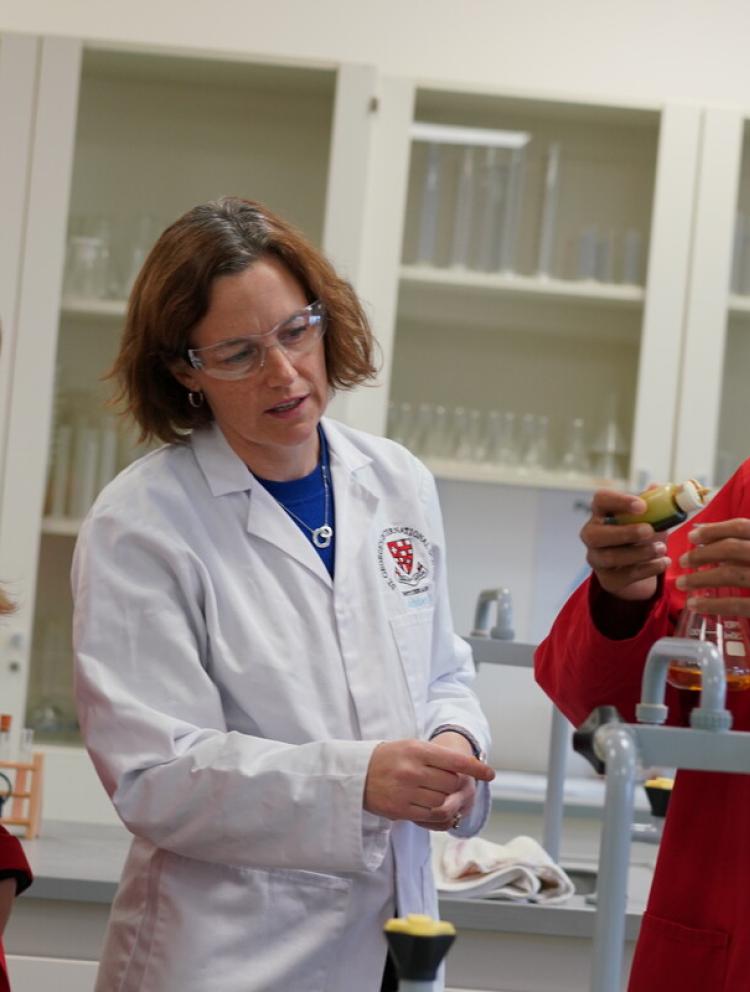 Science teacher conducting experiment with students