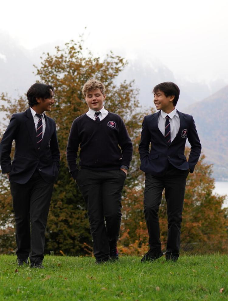 Students outside walking on grass