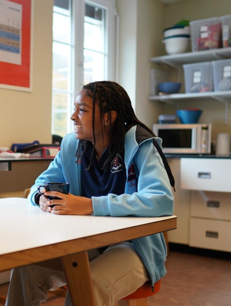students in the canteen talking and smiling