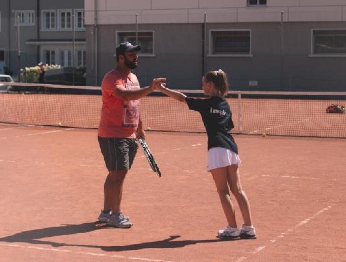 summer camp student with tennis coach