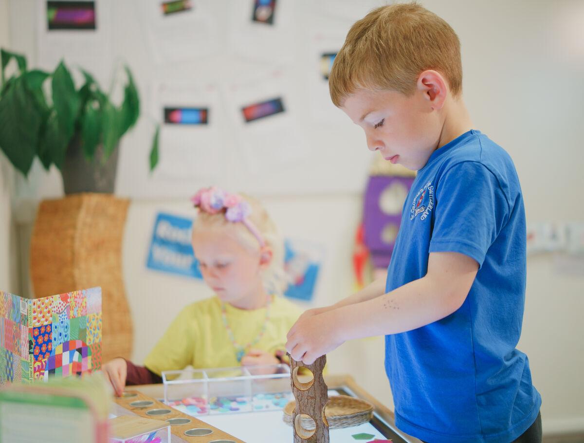 primary school student playing with building blocks