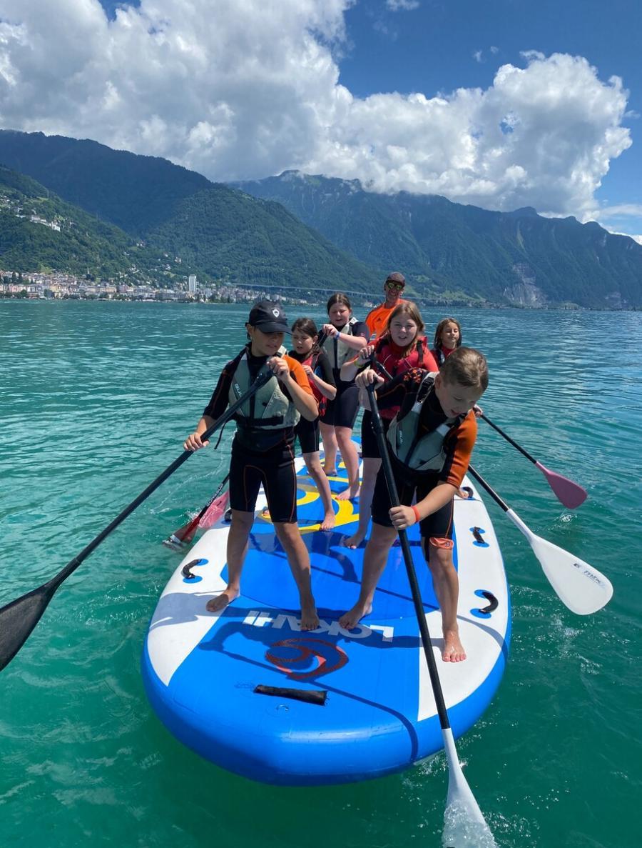 Children paddleboarding on turquoise water
